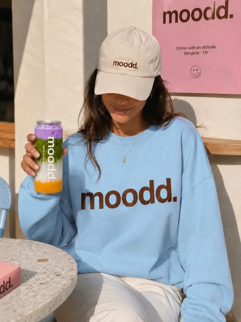 Woman enjoying Moodd drinks at a café